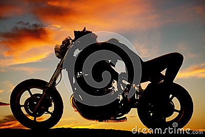 Woman lay on back of motorcycle silhouette