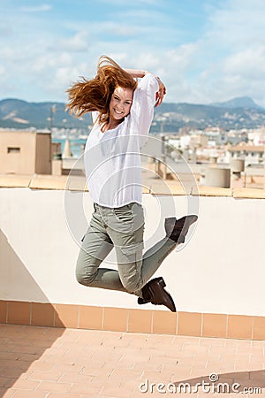 Woman leaping on a flat roof