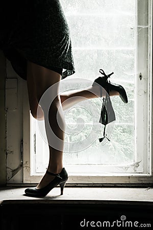 Woman legs on the window