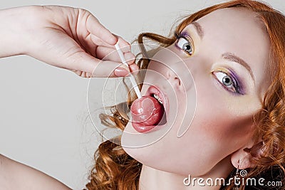 Woman licking candy