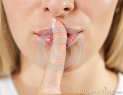 Woman lips with finger shh