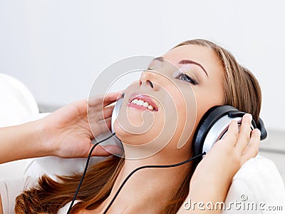 Woman listening music in headphone