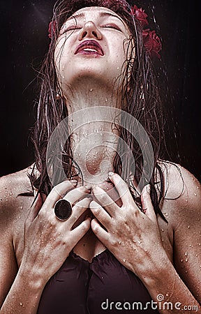 Woman with a long neck, beautiful shoulders, wet hair and tragic expression on his face