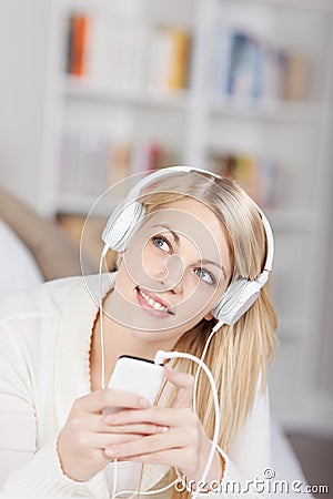 Woman Looking Up While Listening Music On Headphones