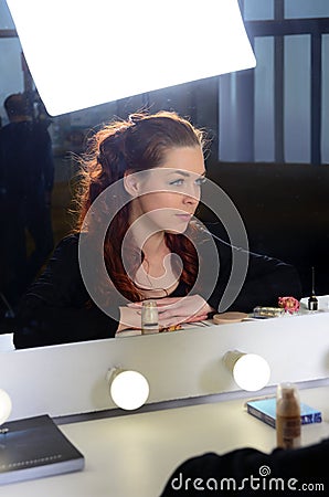 Woman looks in the mirror