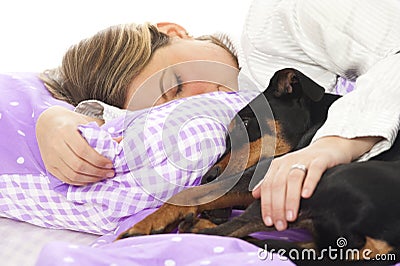 Woman lying in bed with dog