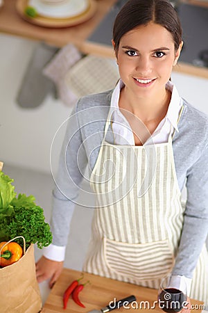 Woman making healthy food standing smiling in