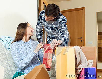 Woman and man together with clothes and bags