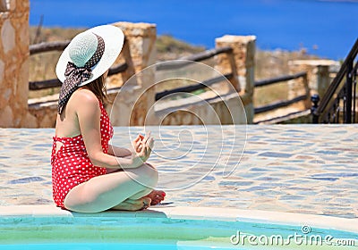 Woman meditation near the pool
