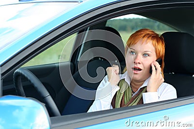 Woman with mobile in a car