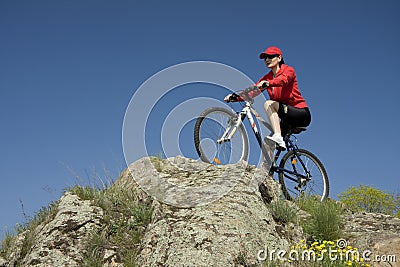 The woman on mountain bicycle