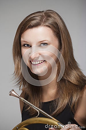 Woman musician with french horn