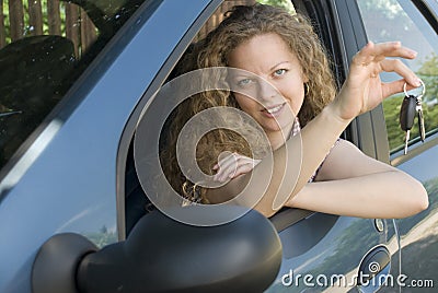 Woman offering keys to her new car