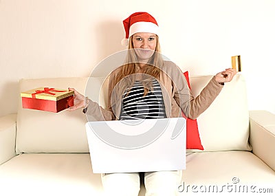 Woman online Christmas shopping with computer and credit card