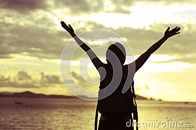 Woman open arms to sunrise