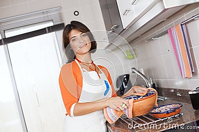Woman opening the kitchen oven