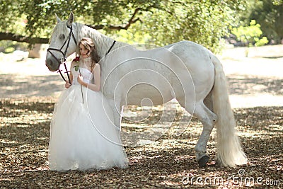 Woman Outdoors With a White Horse