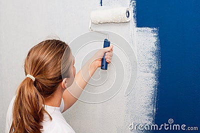 Woman painting a wall