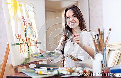 Woman paints on canvas