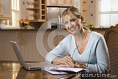 Woman paying bills on computer.