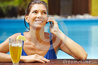 Woman with phone in pool