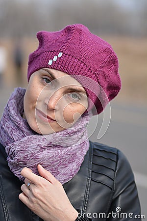 Woman in pink beret and black leather jacket