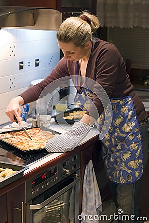 Woman and pizza in kitchen