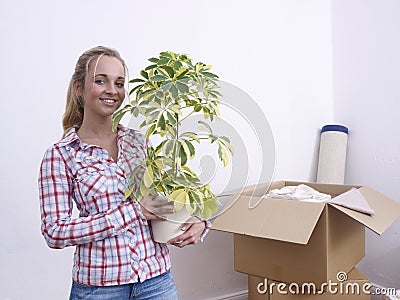 Woman with plant and boxes