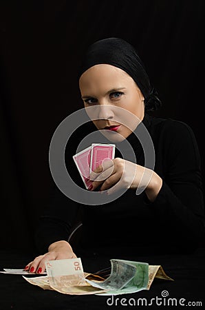 Woman with playing cards and money