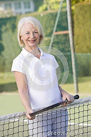 Woman playing tennis and smiling