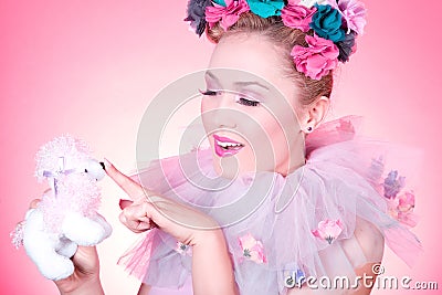 Woman is pointing a toy poodle nose