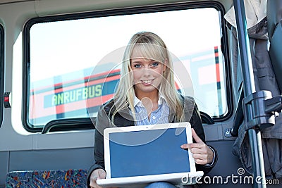 Woman points at the laptop-display inside a bus
