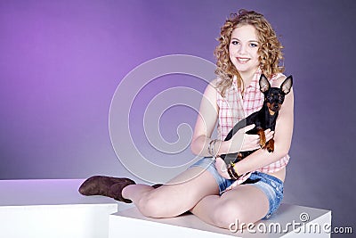 Woman posing with dog on cube