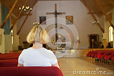 Woman praying in church