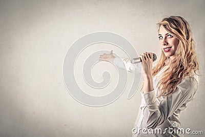 Woman presenting someone with a microphone