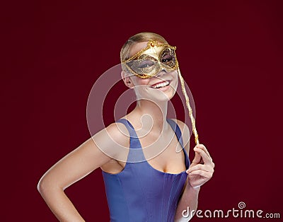 Woman puts on masquerade mask