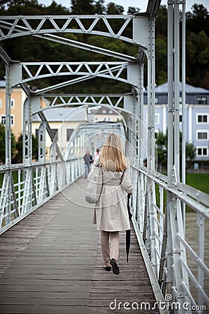 Woman in a raincoat walking away