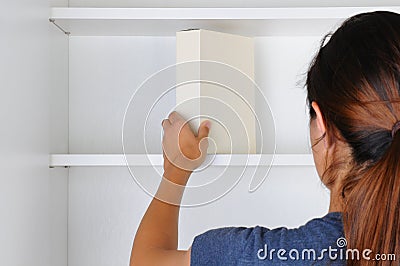 Woman Reaching Into Cupboard