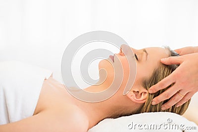 Woman Receiving Head Massage At Health Spa