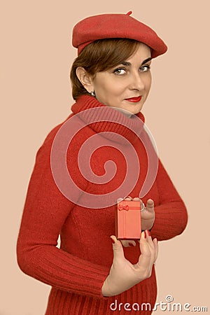 Woman in red with beret holding a gift