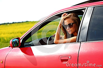 Woman in red car