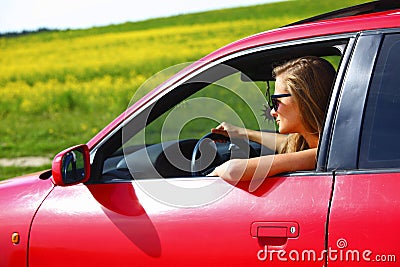 Woman in red car