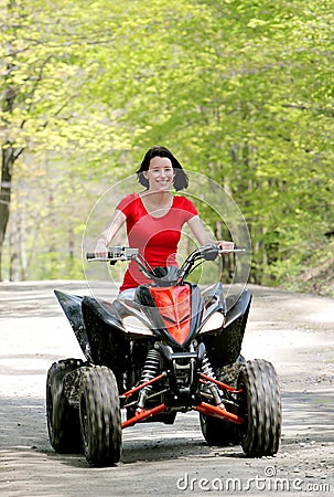 Woman in red on four wheeler
