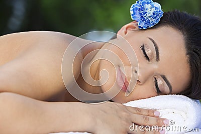 Woman Relaxing At Health Spa With Blue Flower