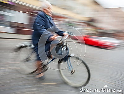 Woman rides a bicycle through the streets