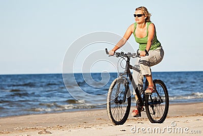 Woman riding bicycle in beach