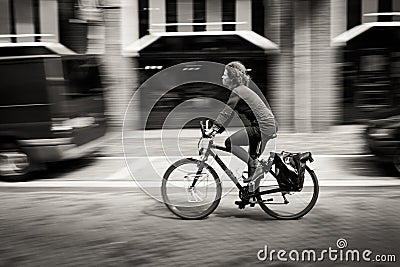 Woman riding a bicycle down the street. Amsterdam