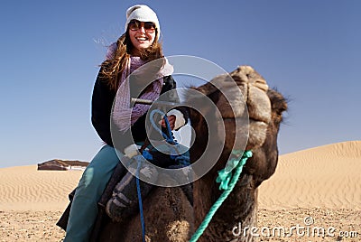 Woman riding a camel