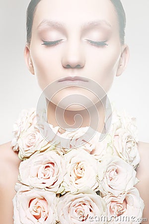 Woman in a rose necklace and with wedding make-up