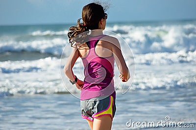 Woman running on beach, girl runner jogging outdoors